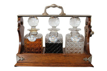 Load image into Gallery viewer, Antique English Oak Tantalus with Three Cut Crystal Decanters, c. late 1800s
