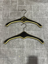 Load image into Gallery viewer, MCM Regency Black and Gold Wood Clothes Hangers - Monogrammed with U and V
