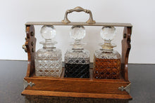 Load image into Gallery viewer, Antique English Oak Tantalus with Three Cut Crystal Decanters, c. late 1800s
